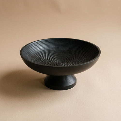 Korren matte black footed bowl with concentric rings inside, empty, on a warm neutral background