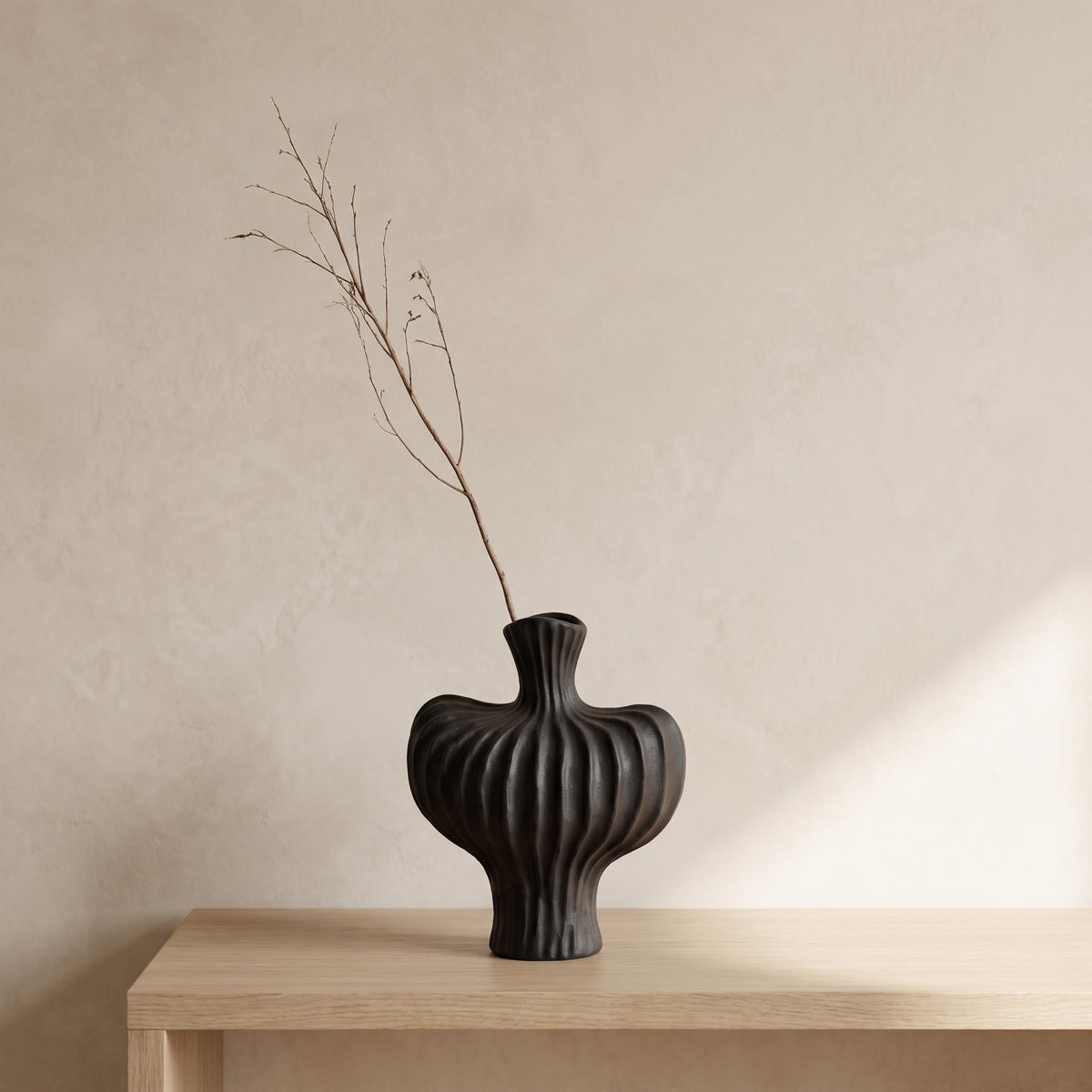 Teja ribbed ceramic vase in black on an oak console