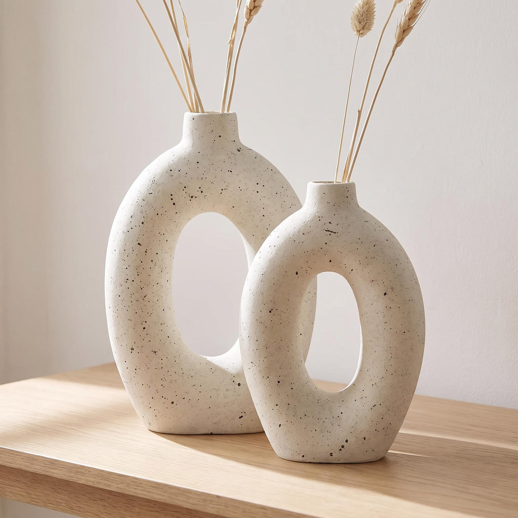 Alburo ring vases on a console holding slim dried stems