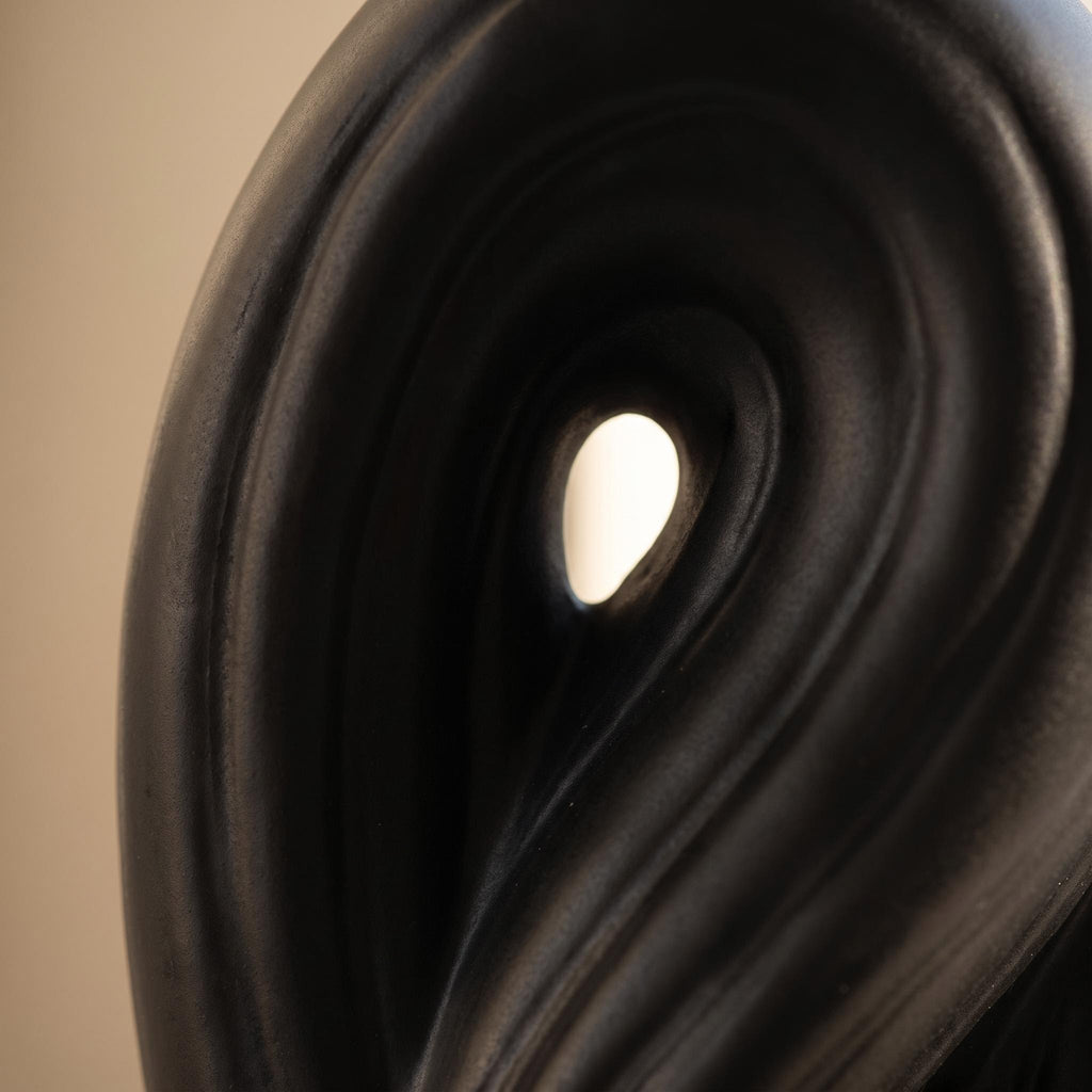 Close-up of the twisted matte black surface and opening of the Umbra vase