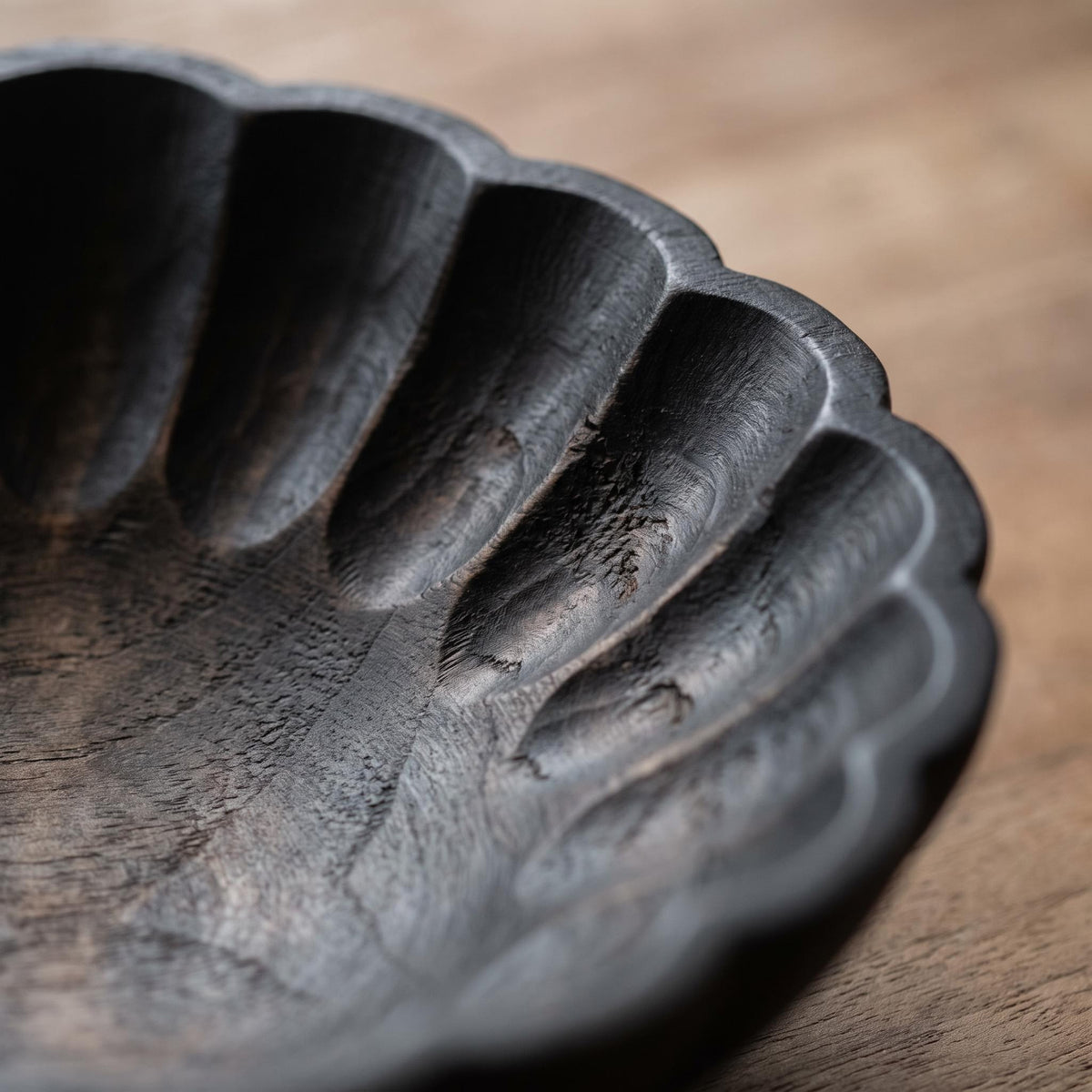 Close-up of the carved scalloped rim and gouge marks inside the Ondel bowl