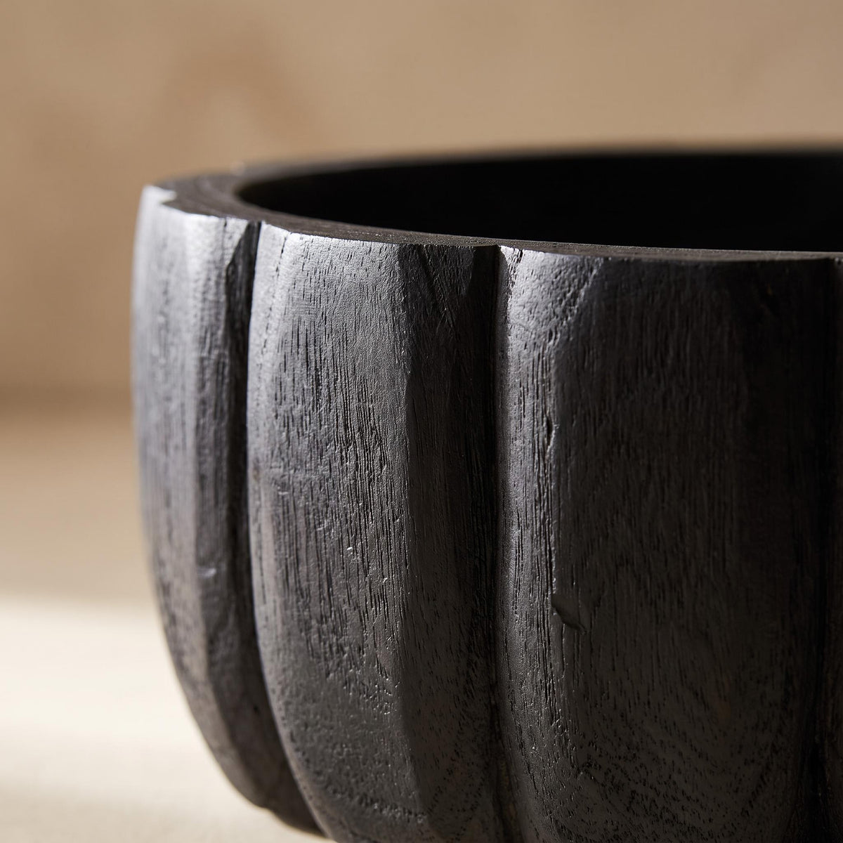 Close-up of two carved vertical lobes on the outside of the Ondel bowl
