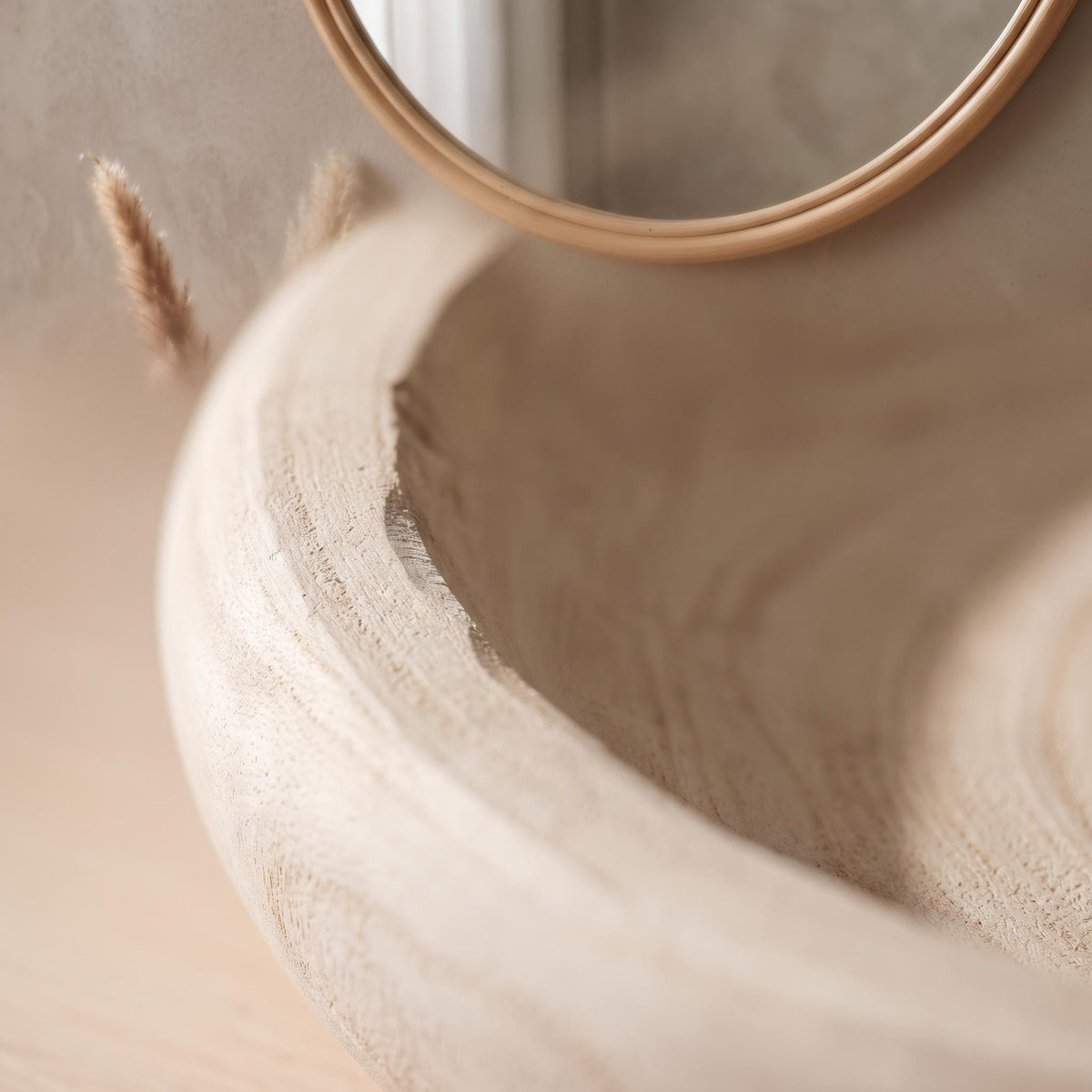 Close-up of the carved rim and pale driftwood grain of the Velto bowl