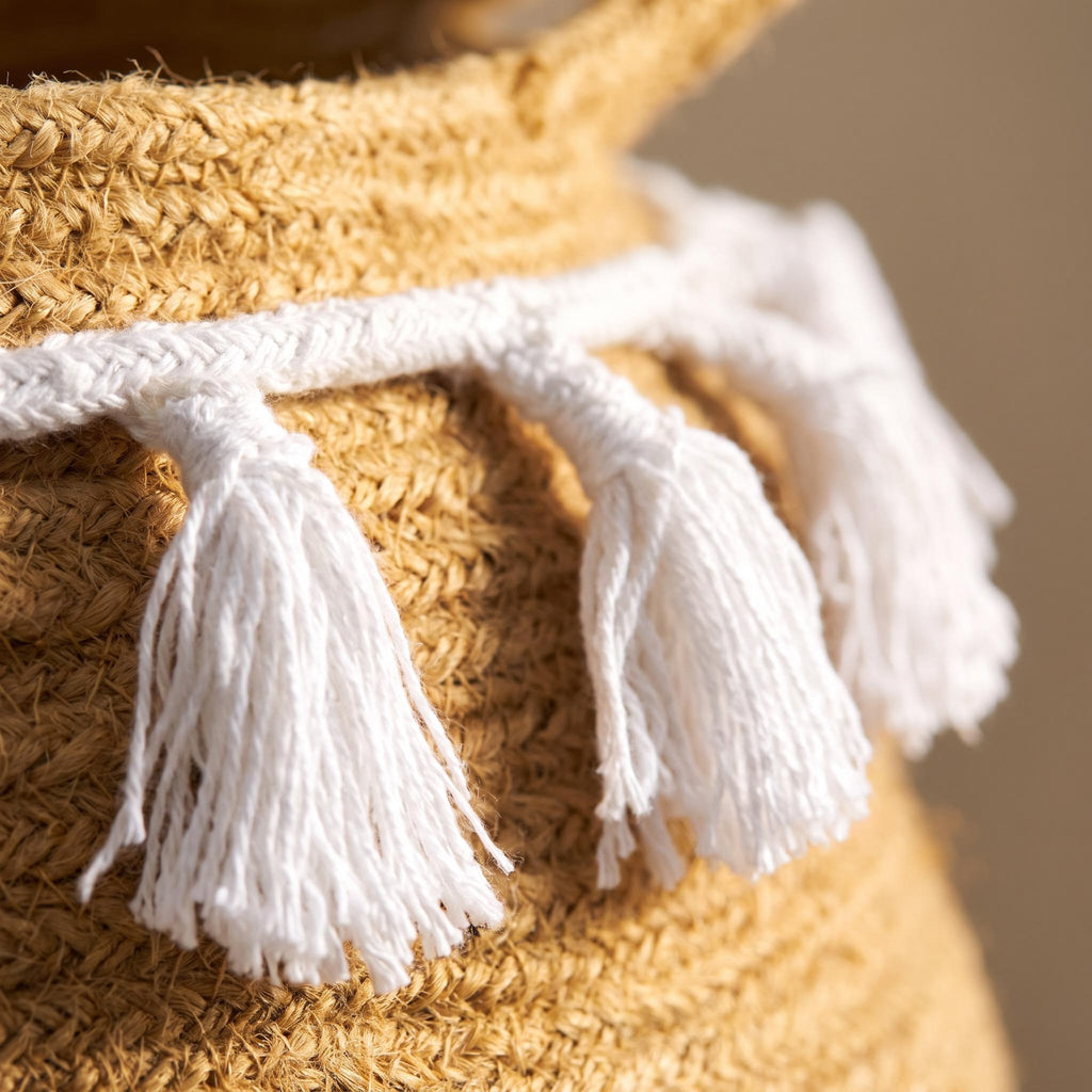 Close-up of the white tassels against the coiled cotton rope of the Ombela basket