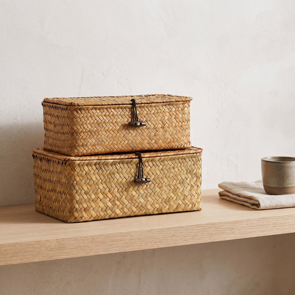 Ostria baskets stacked on a pale oak shelf beside a linen cloth