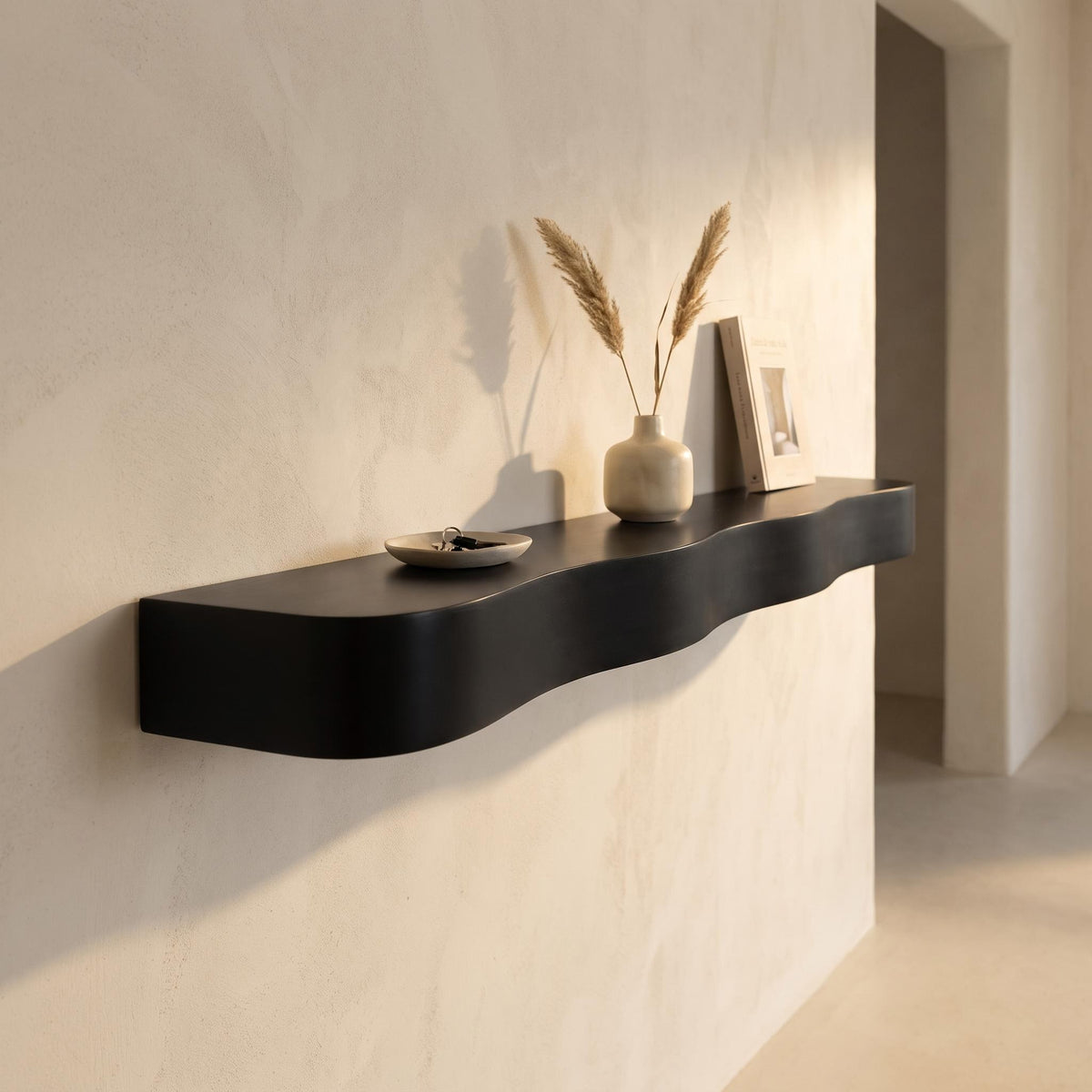 Bruko shelf in a hallway holding a ceramic dish, a vase and a book