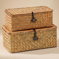 Ostria pair of lidded seagrass baskets stacked on a warm neutral background