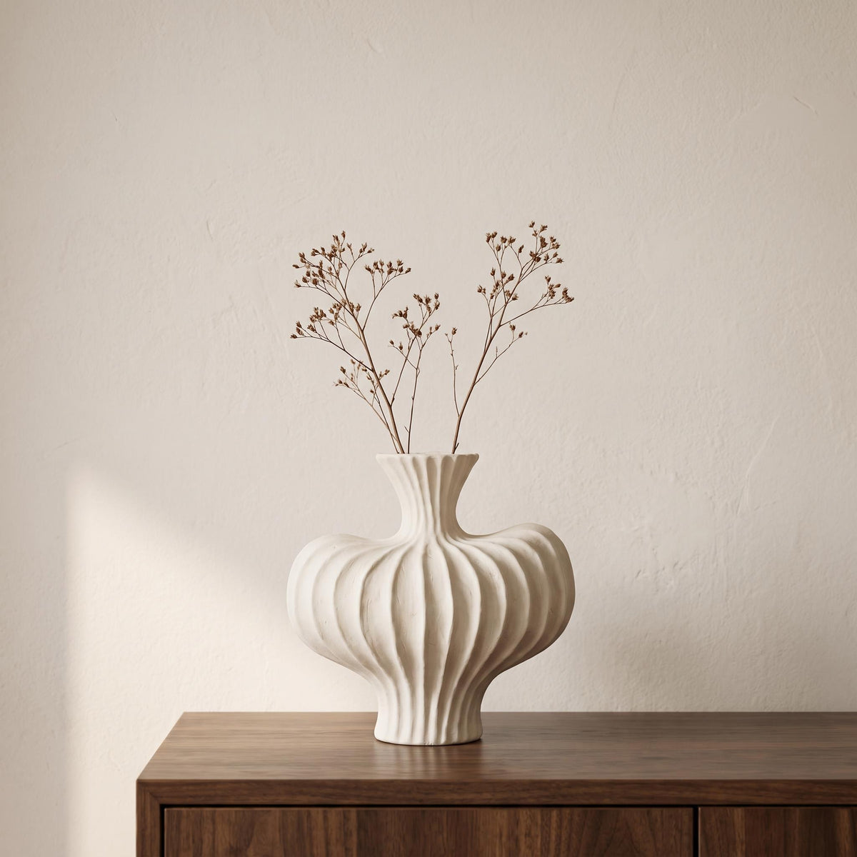Teja ribbed ceramic vase in white on a walnut sideboard