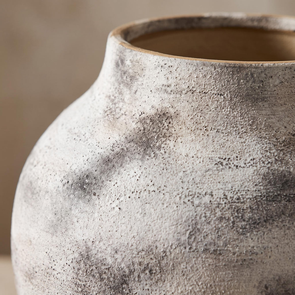 Close-up of the chalky grey and white mottling and bare clay rim of the Elvra vase