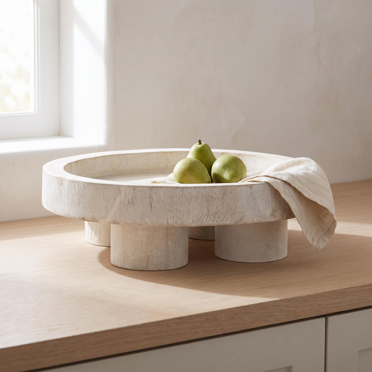 Nuko tray on a kitchen counter holding pears and a linen napkin