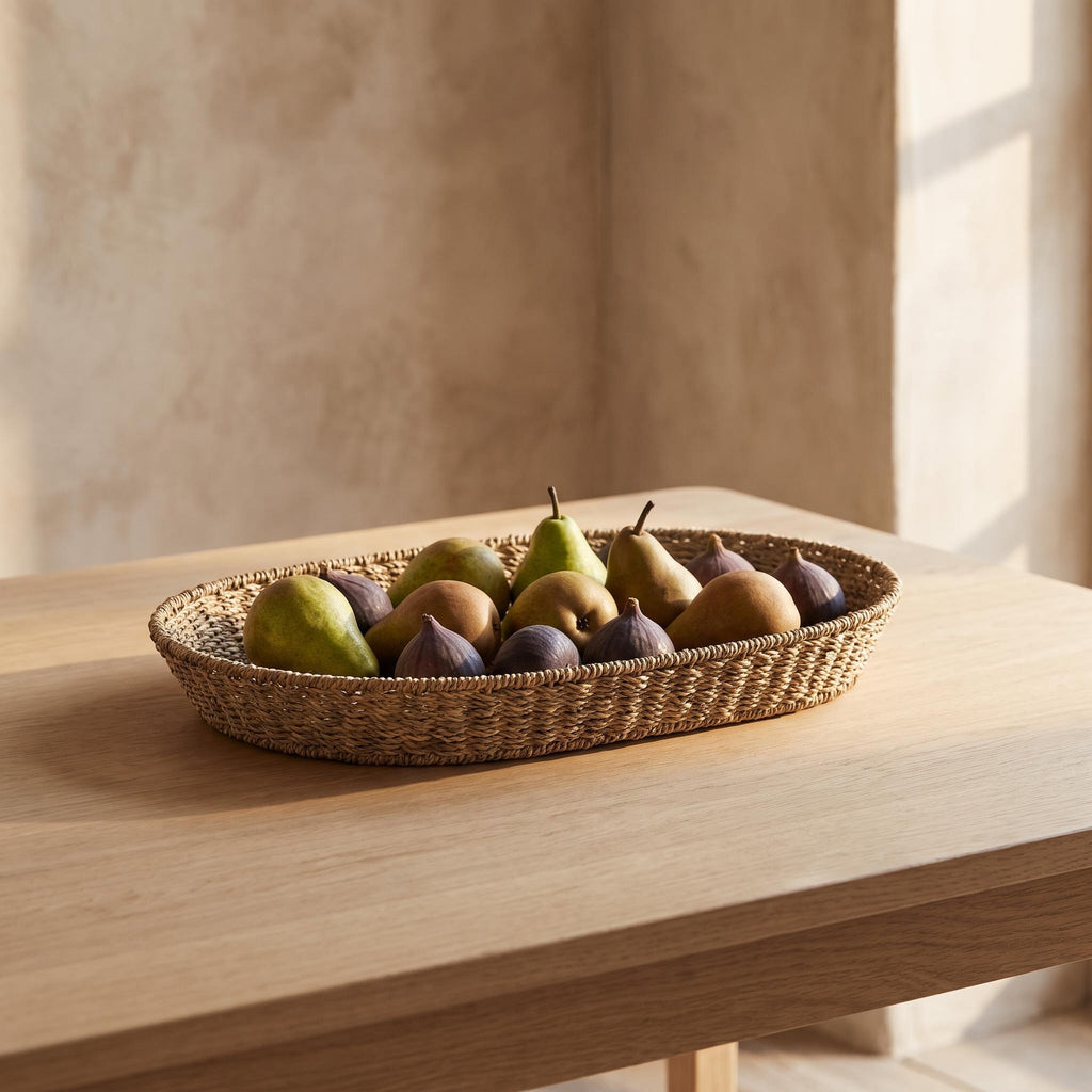 Marea basket on a dining table holding pears and figs in a single layer