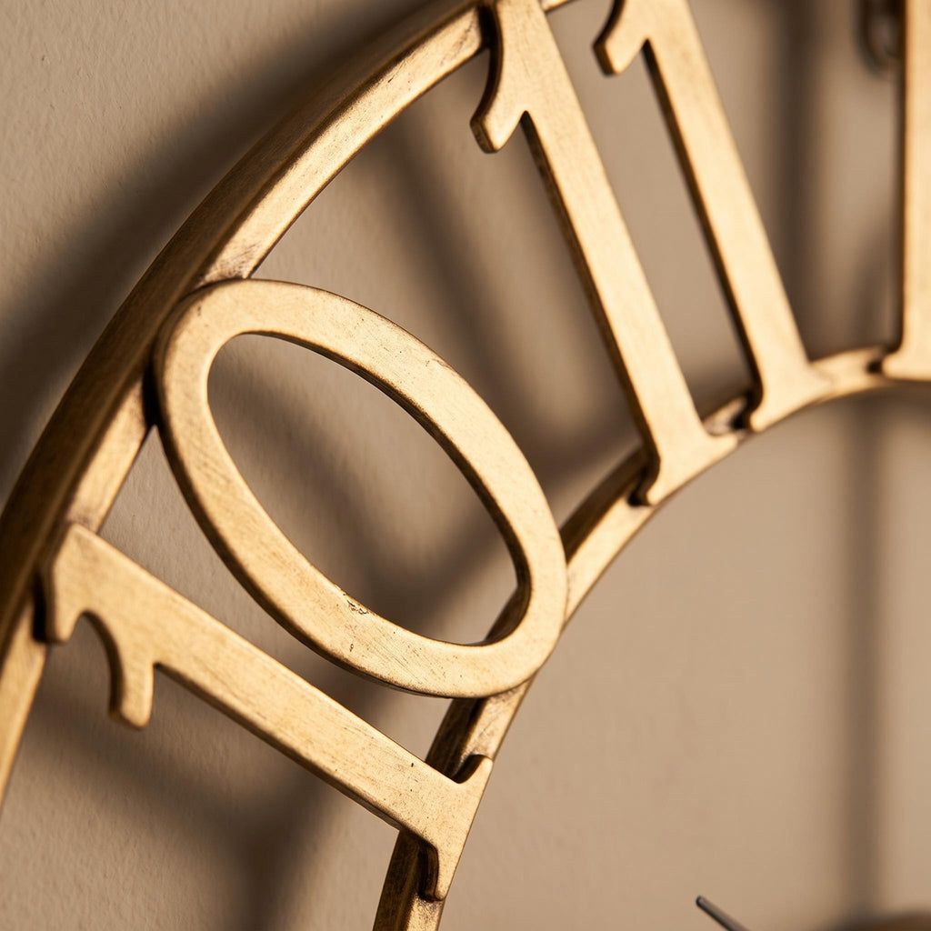 Close-up of the cut-out numerals and antique gold finish of the Lunea clock