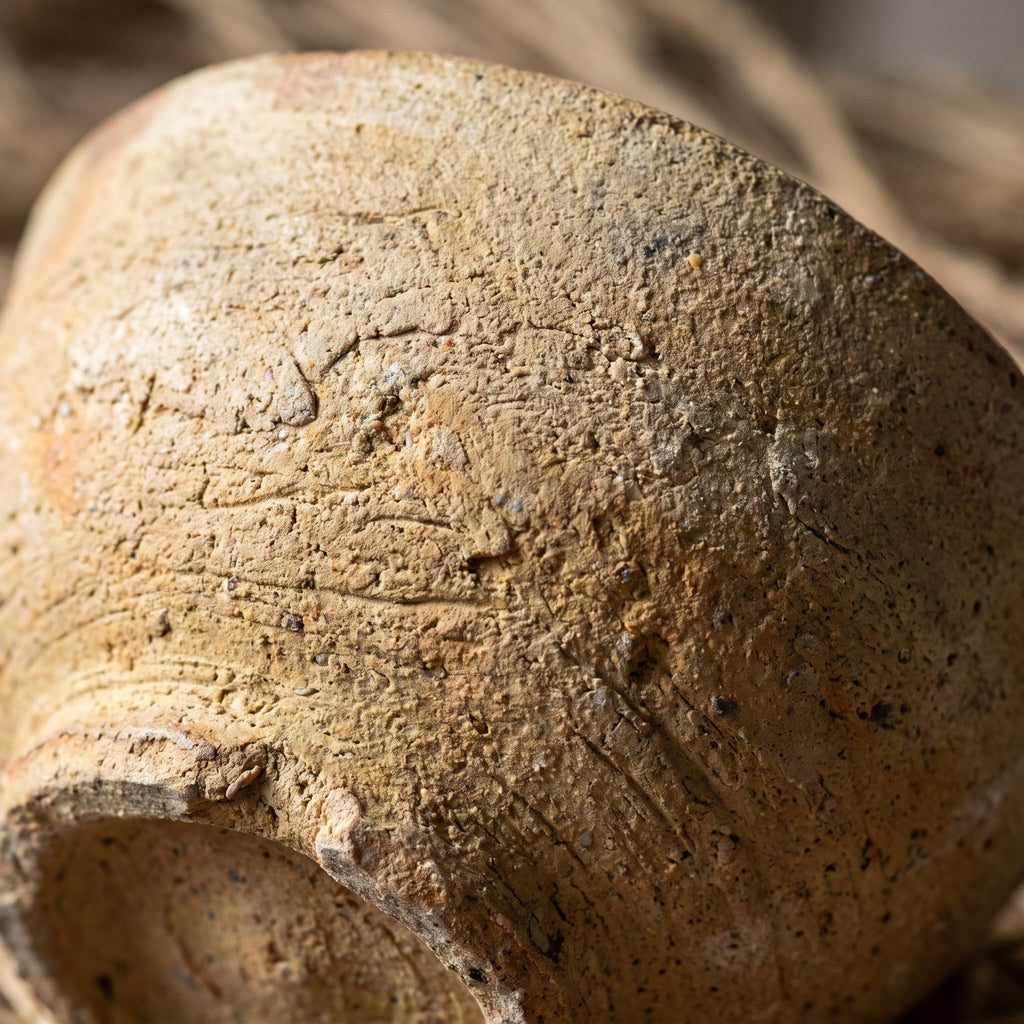 Close-up of the rough unglazed clay surface and low foot of the Cálida bowl