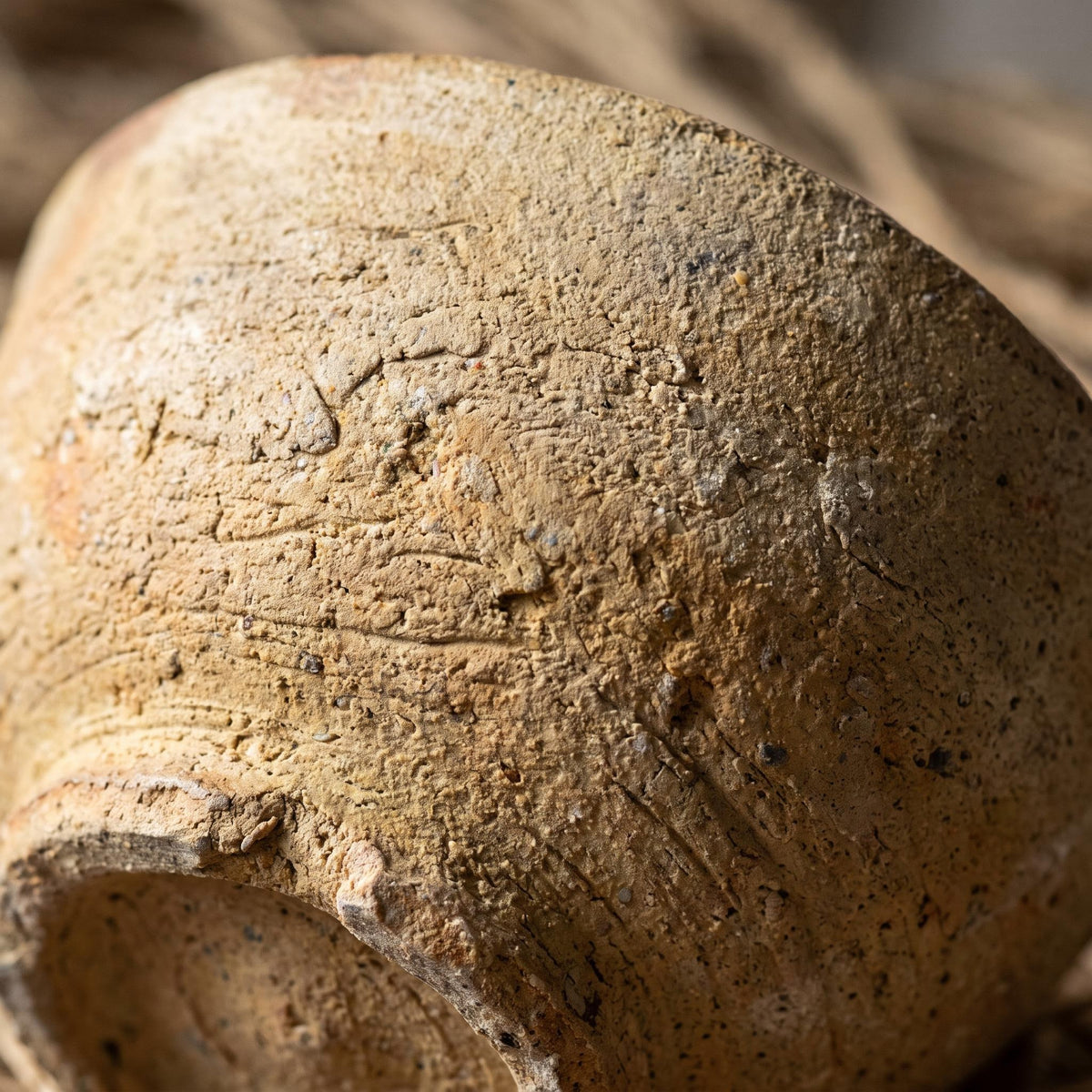Close-up of the rough unglazed clay surface and low foot of the Cálida bowl