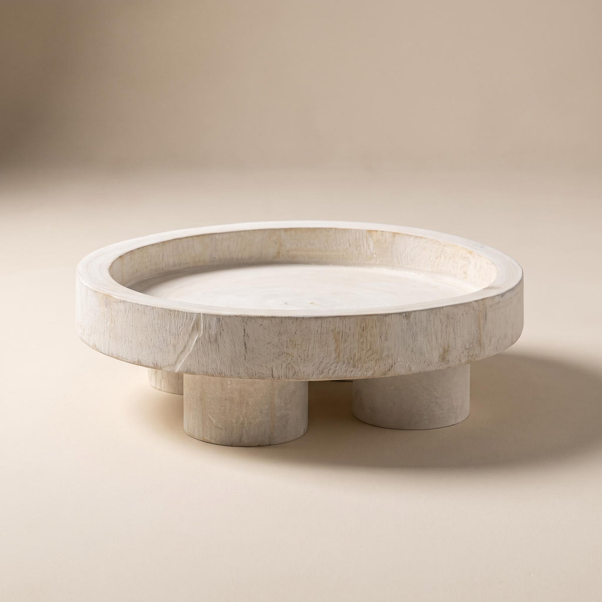 Nuko whitewashed paulownia pedestal tray, empty, on a warm neutral background