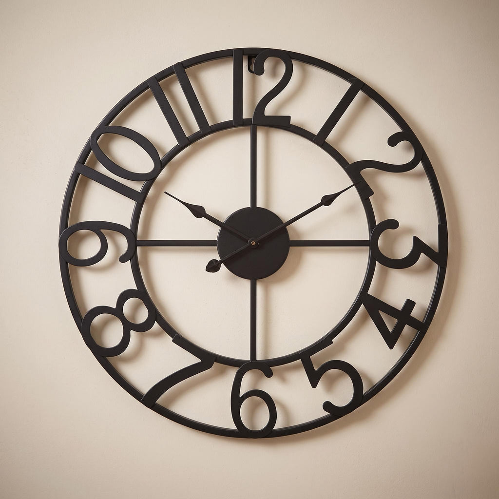 Lunea wall clock in black with dark hands on a warm neutral wall