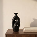 Umbra tall black sculptural vase on a walnut sideboard