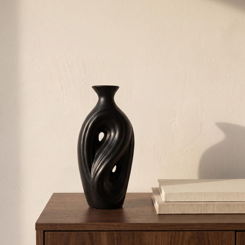 Umbra tall black sculptural vase on a walnut sideboard