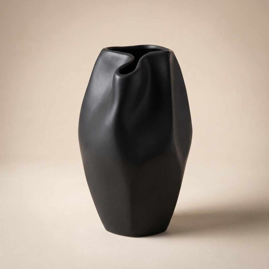 Alven sculptural matte black stoneware vase, empty, on a warm neutral background
