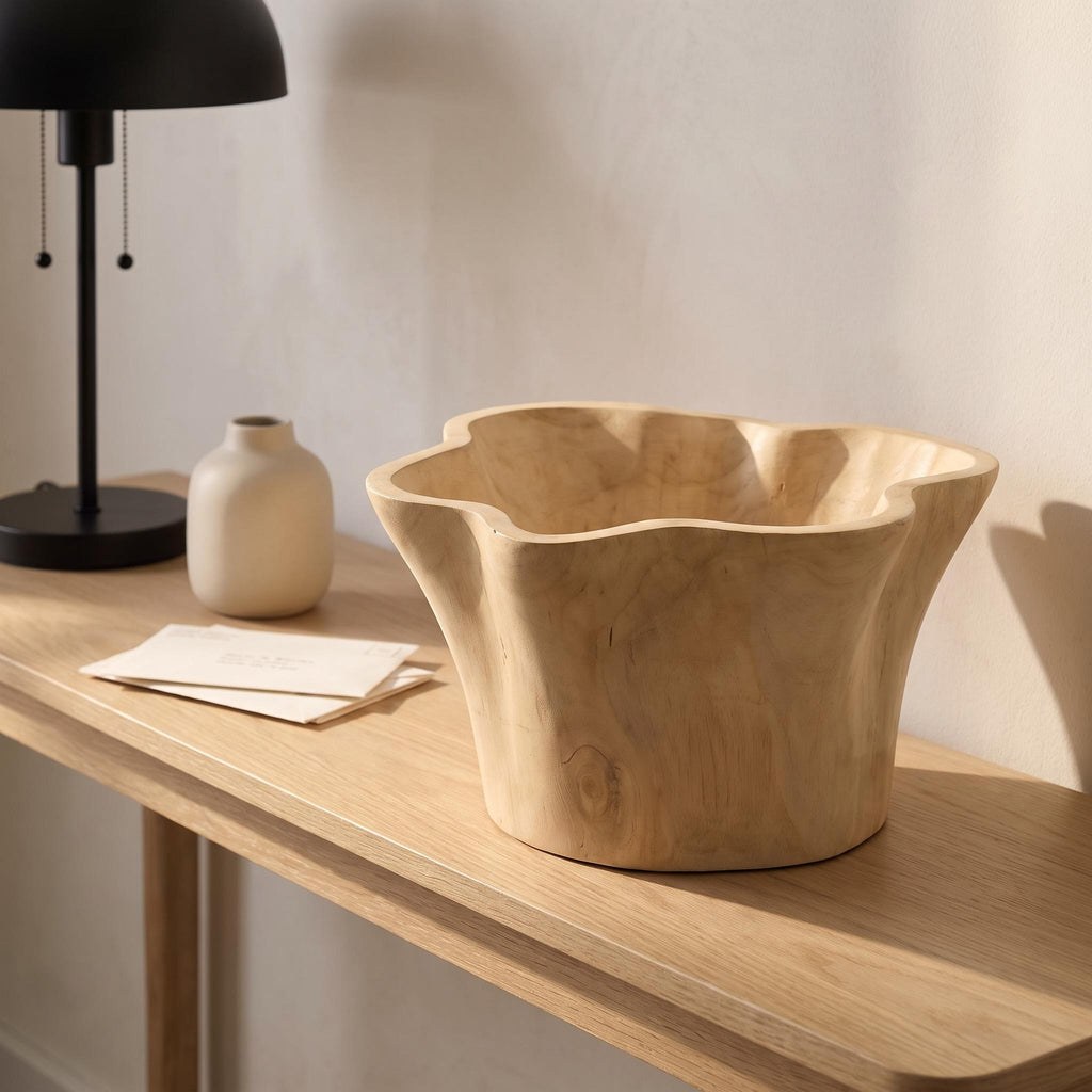 Aurebo bowl empty on an entry console beside a small vase