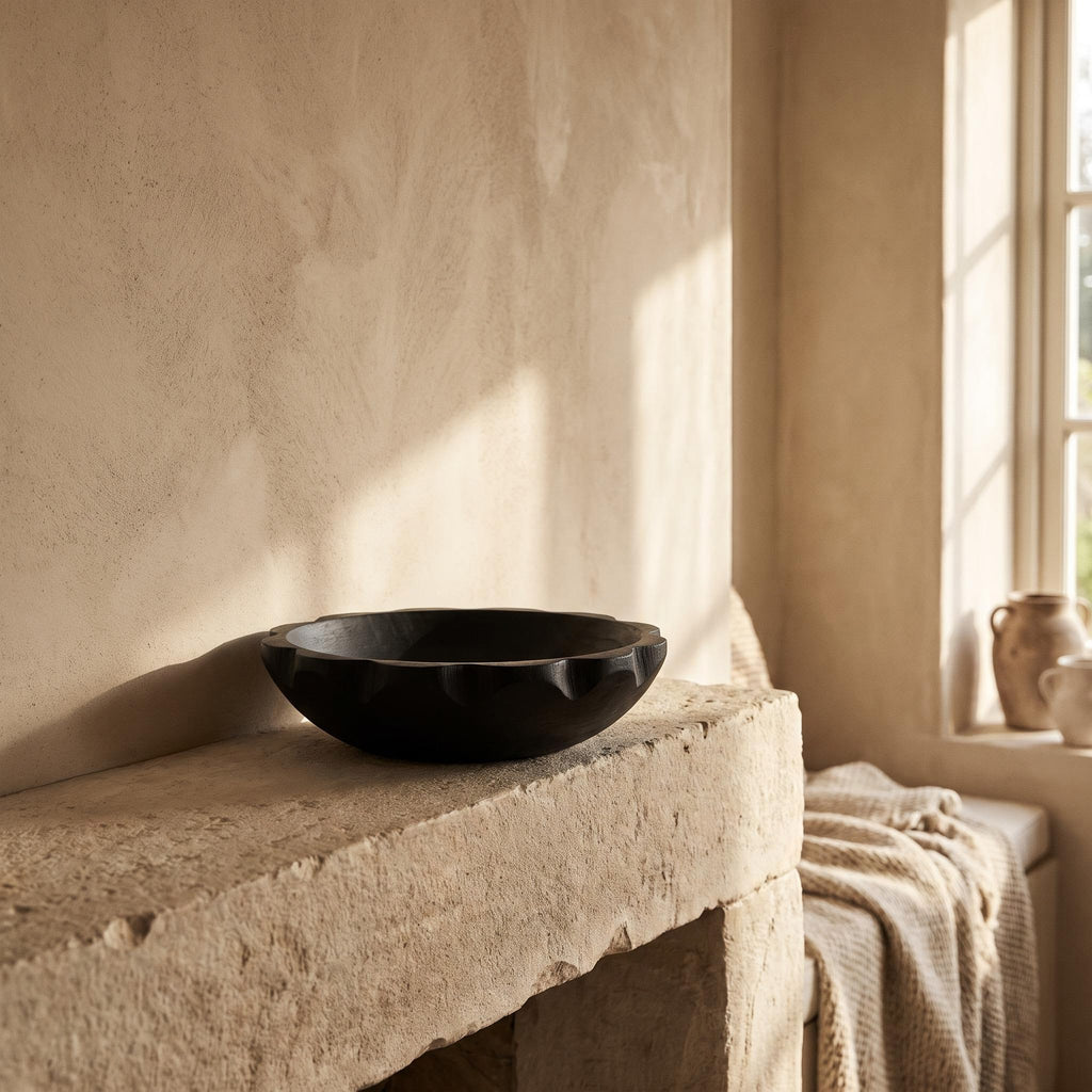 Ondel bowl empty on a limestone mantelpiece in afternoon light