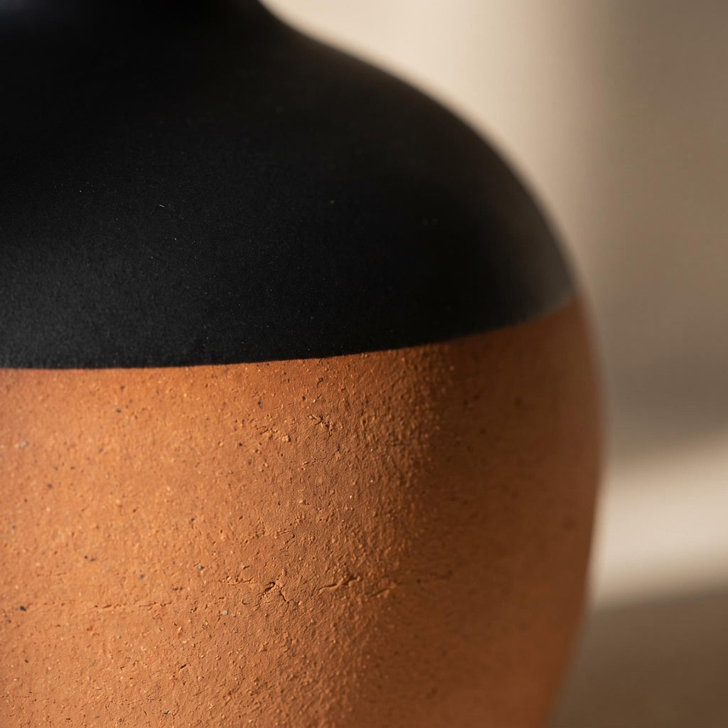 Close-up of the line where terracotta meets matte black on the Terra vase