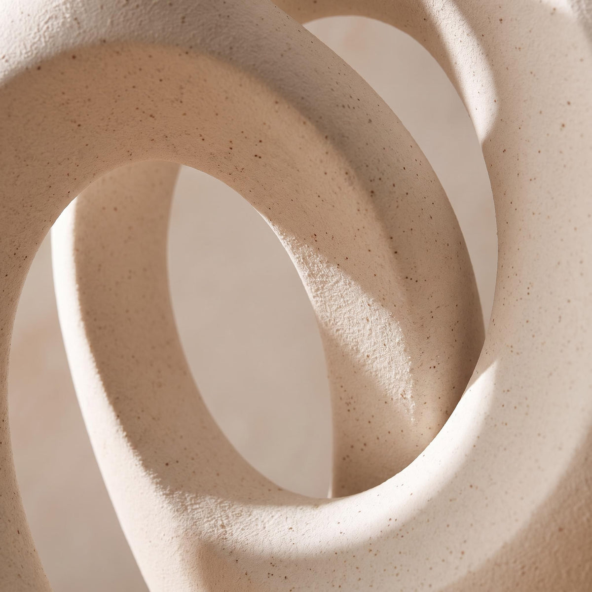Close-up of the matte speckled white ceramic of the Lazo vases