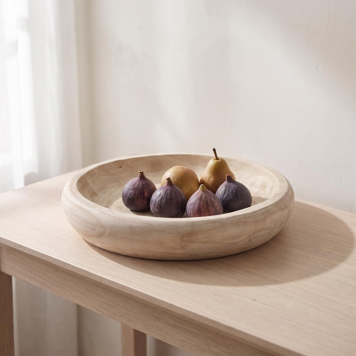 Velto bowl on a console holding figs and pears in a single layer