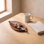 Folha tray next to a coffee mug and a book to show its real size