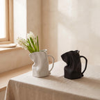 Plica jug vases in white and black on a linen table