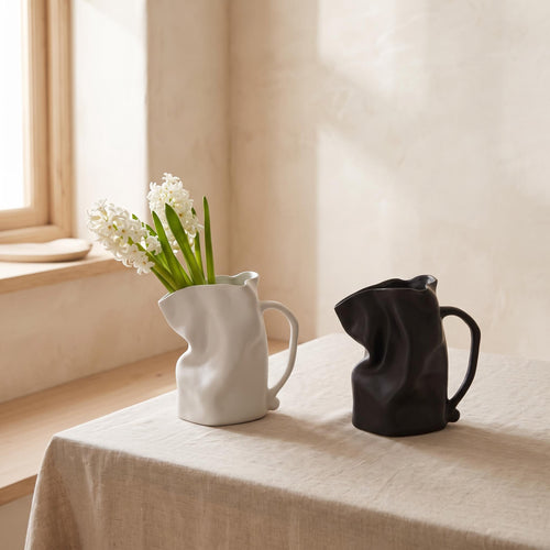 Plica jug vases in white and black on a linen table