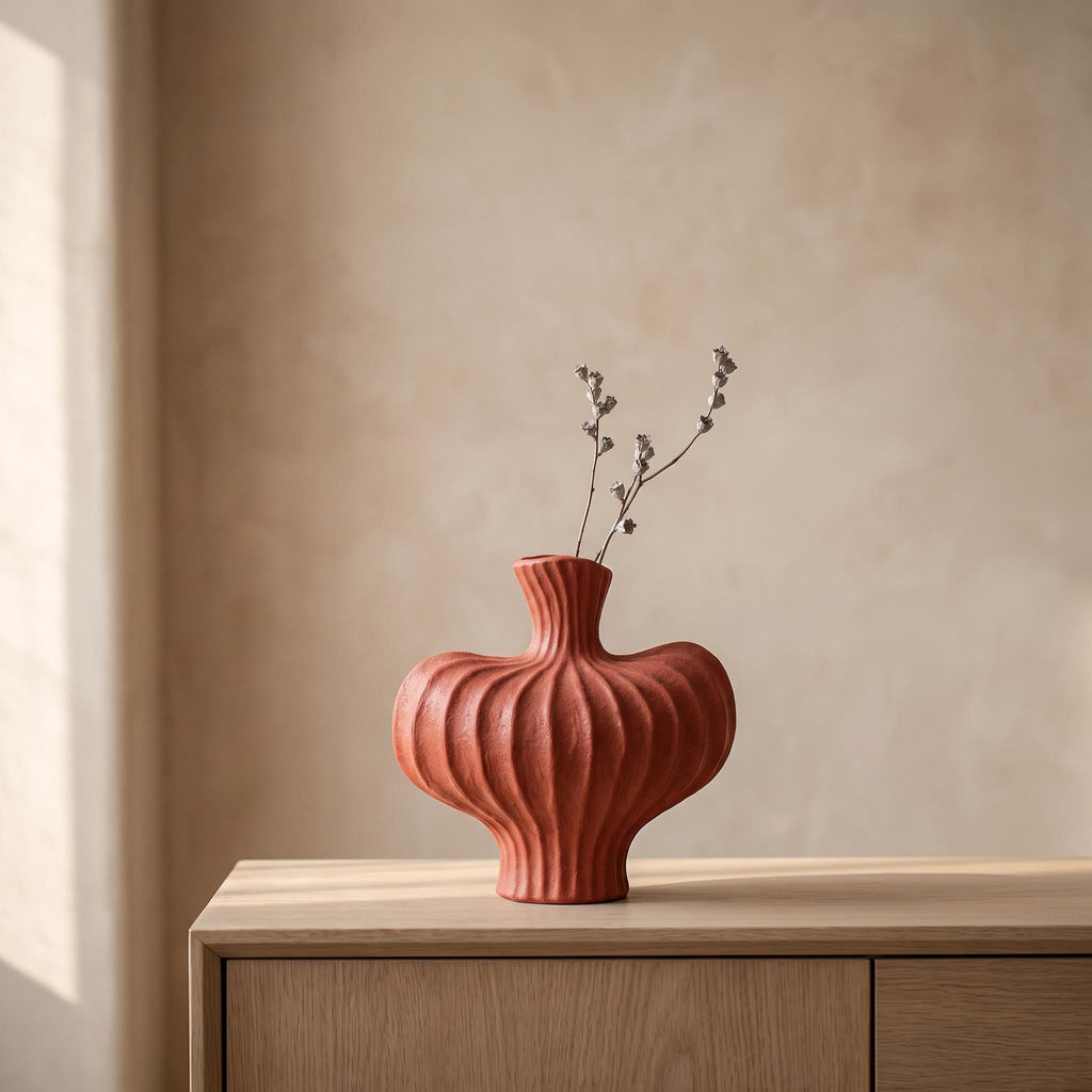 Teja ribbed ceramic vase in brick red on an oak sideboard