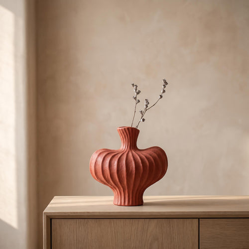 Teja ribbed ceramic vase in brick red on an oak sideboard