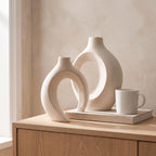 Lazo vase set next to a coffee mug and a book to show its real size