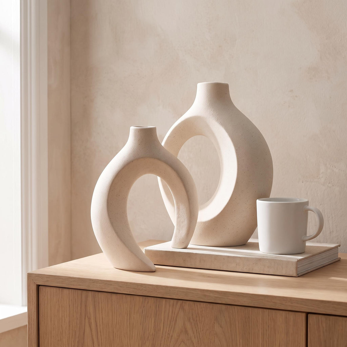 Lazo vase set next to a coffee mug and a book to show its real size