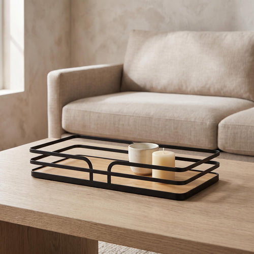 Sável tray on a coffee table holding a ceramic cup and a candle