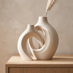Lazo interlocking ceramic vases in white on an oak sideboard