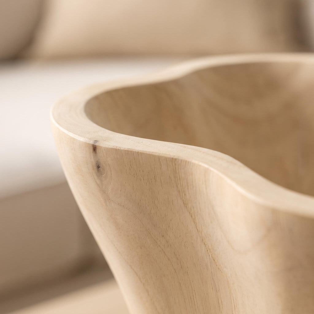 Close-up of the hand-carved rim and pale grain of the Aurebo bowl