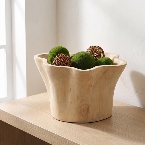 Aurebo carved wooden bowl on a console holding moss spheres and rattan balls