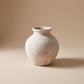 Bianca painted terracotta vase in chalky off-white, empty, on a warm neutral background