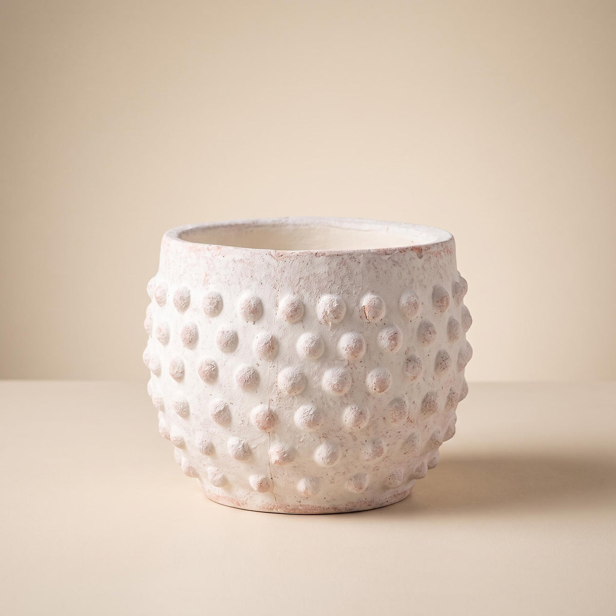 Brumel hobnail terracotta planter, empty, on a warm neutral background